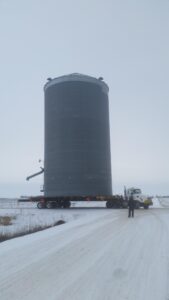Marcus Building Movers moving a silo from one spot on a farm to a different location on the same farm